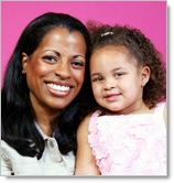 smiling woman of color with her daughter