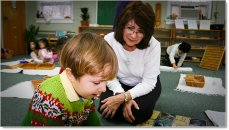 montessori kindergartner teacher working with young boy