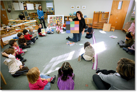 students in a circle learning about colors in montessori classroom