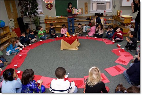 montessori preschool students in a circle with red construction paper